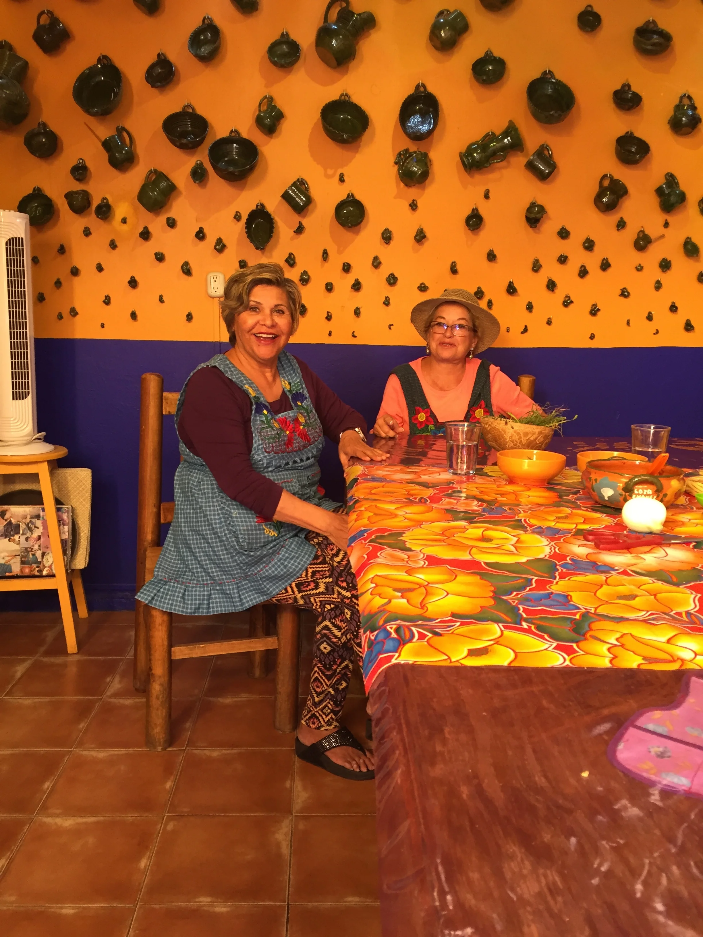 Jeannie and Barbara from Santa Fe, NM, pick herbs while they catch up on all the hot gossip.