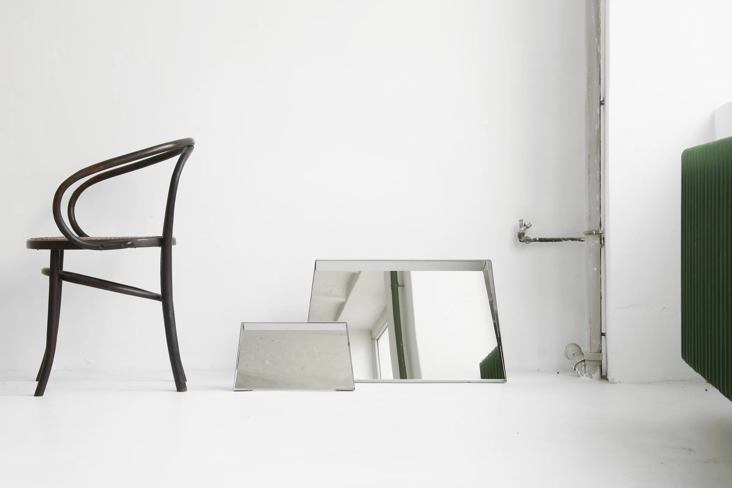 In terms of form, the mirrors present themselves as frames, windows or moveable screens, which reflect ther surrounding environment.