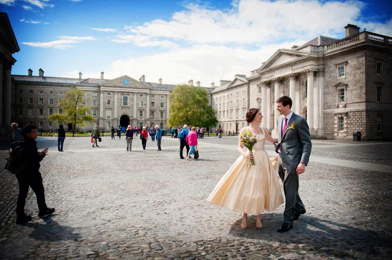 bride and groom in front square trinity college dublin ireland wedding photography