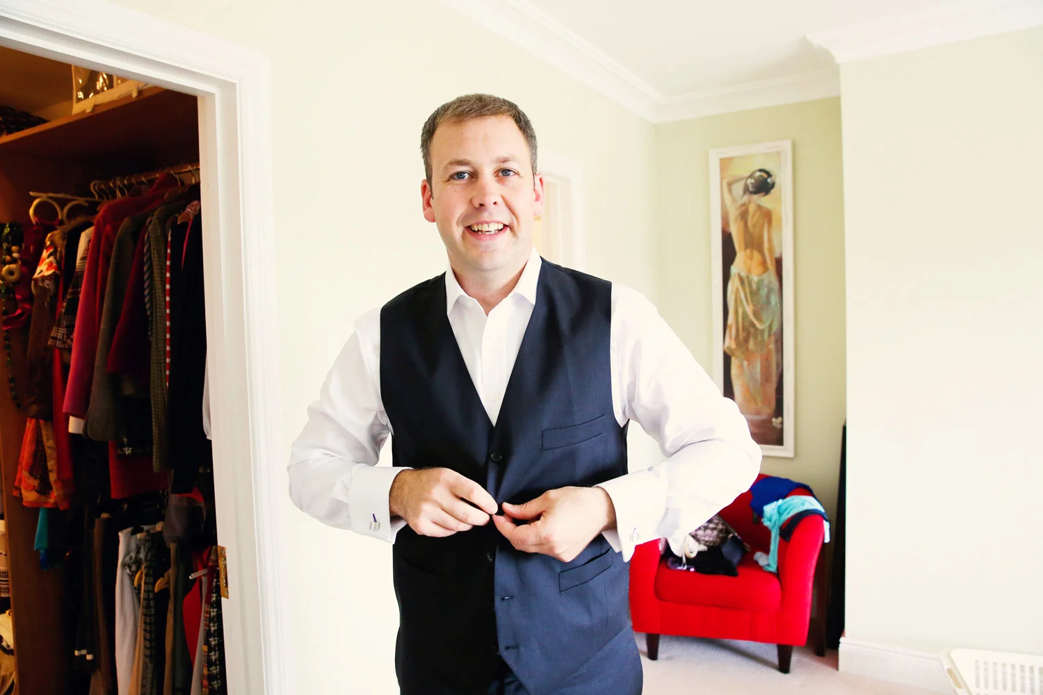 groom buttoning waistcoat kilkenny Ireland Wedding Photography Irish wedding photographers