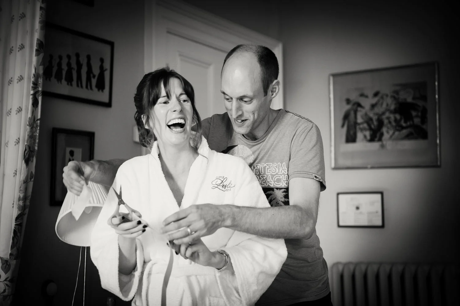 bridesmaid and husband laughing with scissors castle leslie monaghan Ireland Wedding Photography