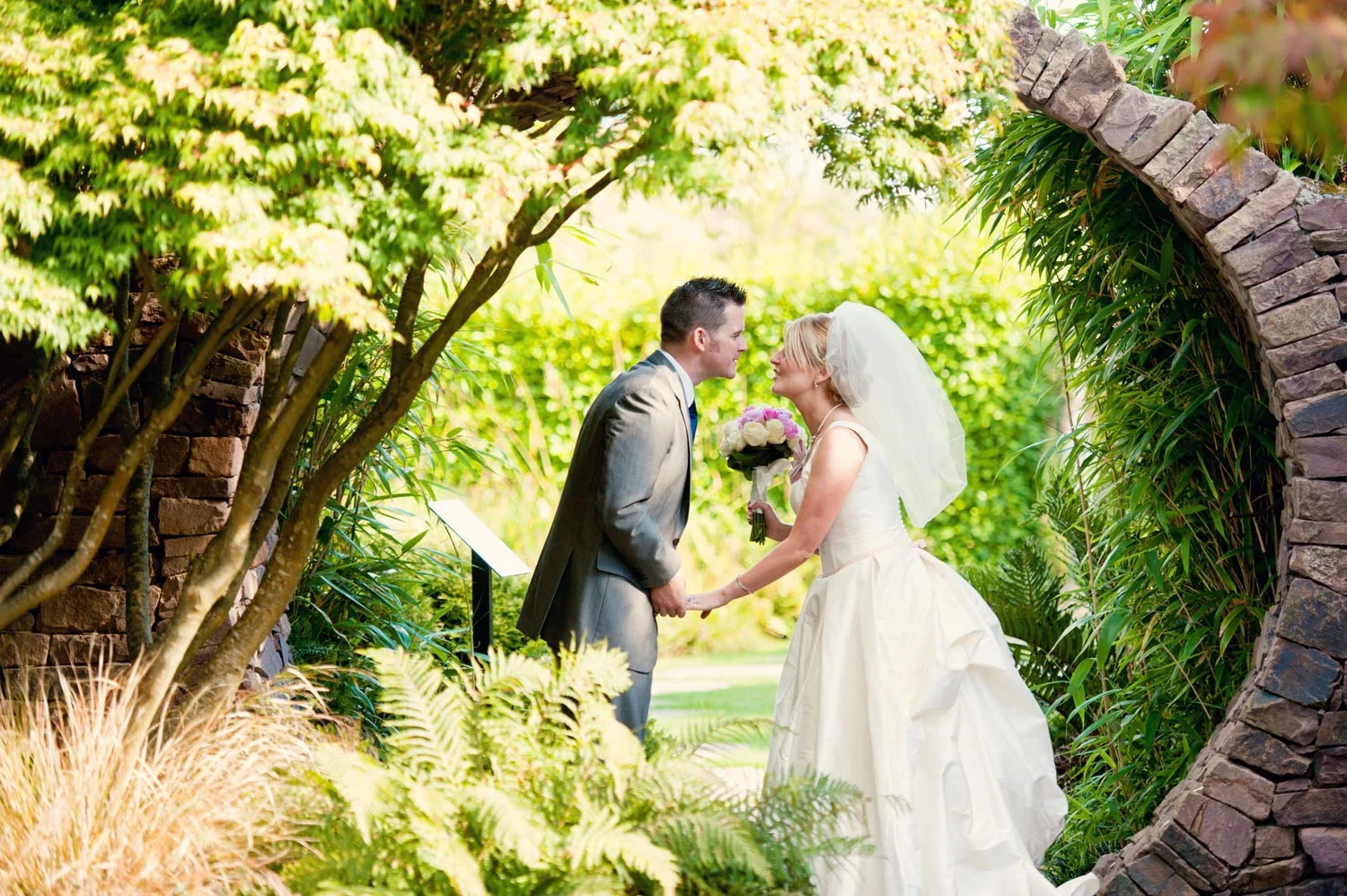 bride and groom about to kiss by walled garden druids glen wicklow ireland wedding photography
