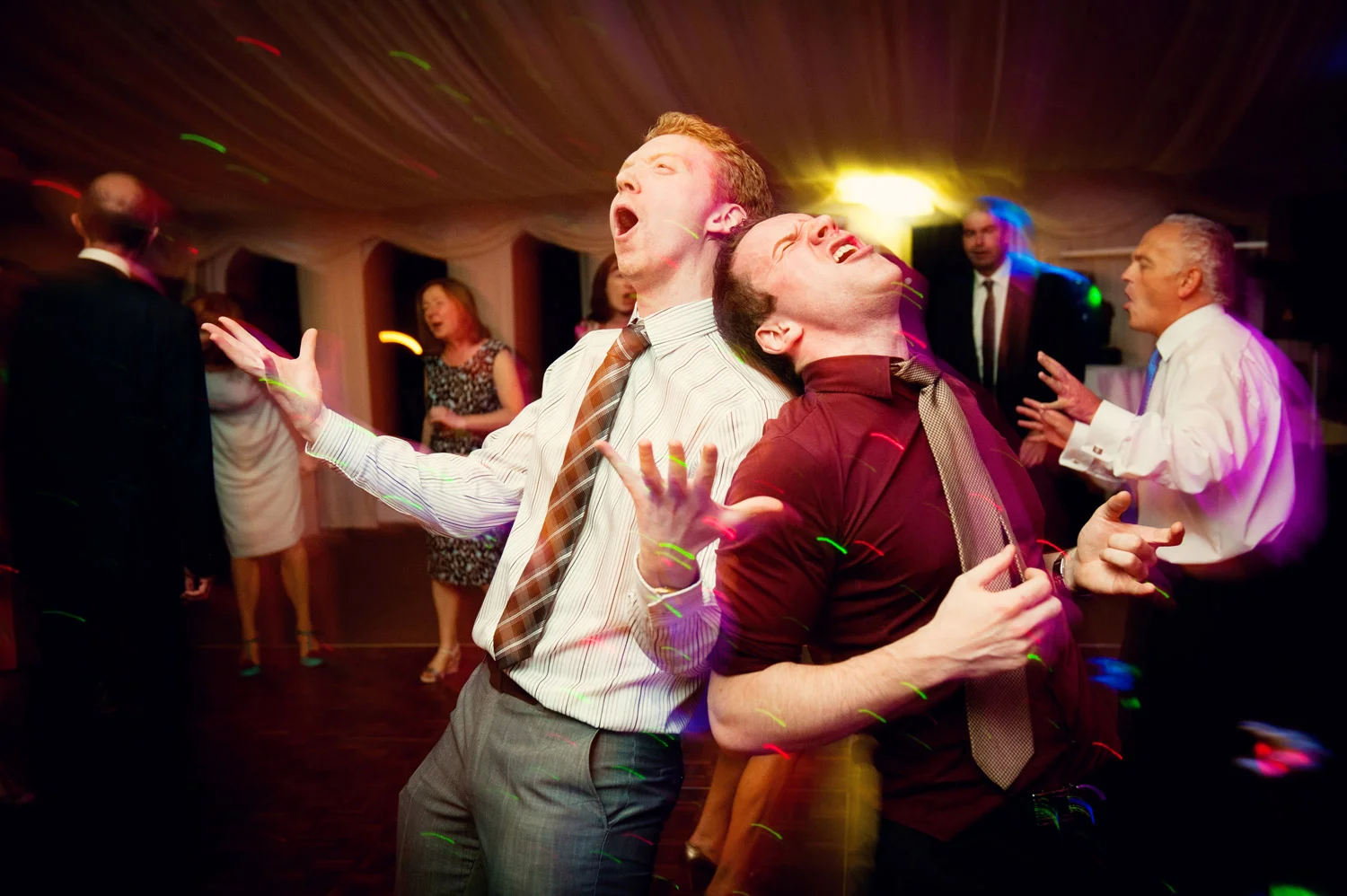 Two guests rocking on the dancefloor Castle Leslie Monaghan Ireland Wedding Photography