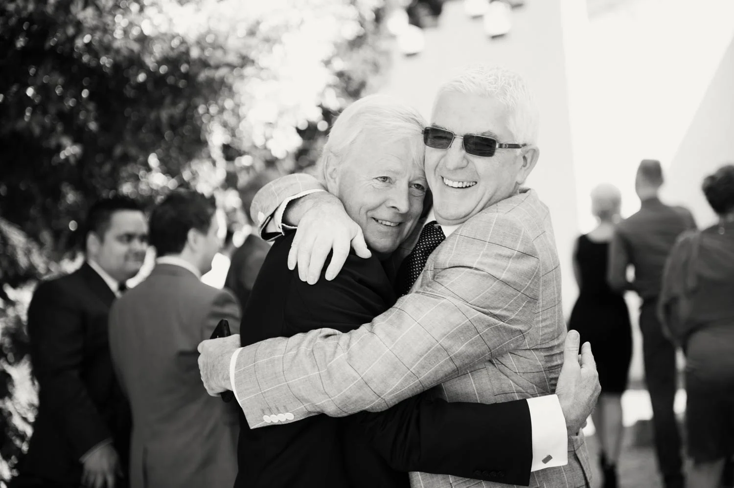 father of bride hugging guest wicklow Ireland Wedding Photography Irish wedding photographers