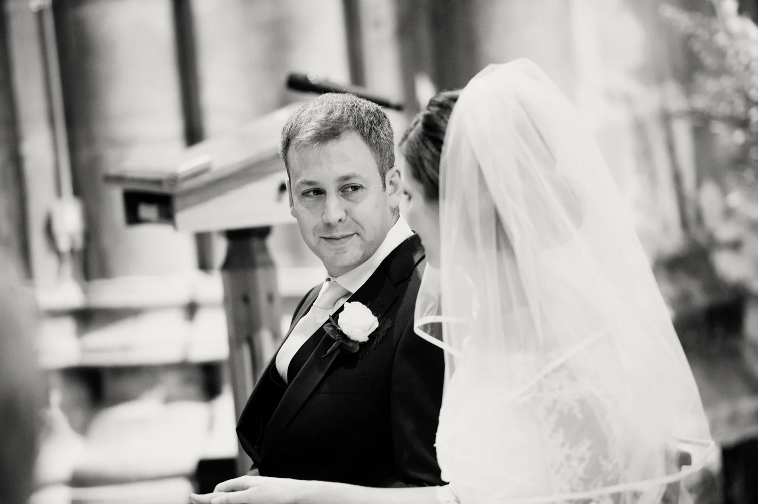 groom looking at bride in kilkenny cathedral Ireland Wedding Photography Irish wedding photographers