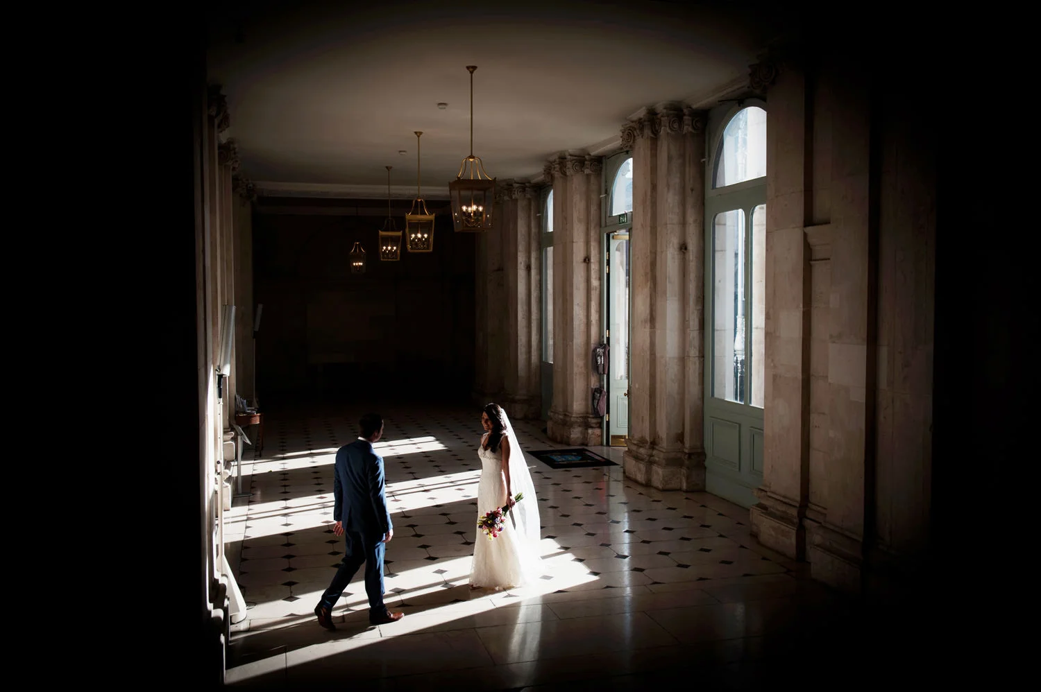 Dublin City Hall Wedding. Bride and groom in sunbeam in the hall.