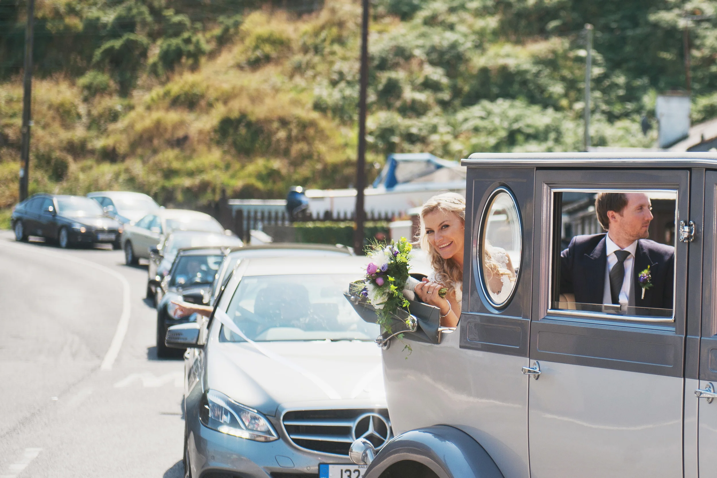 Bride and groom leaving the church in their wedding car in passage east, Waterford, Ireland.