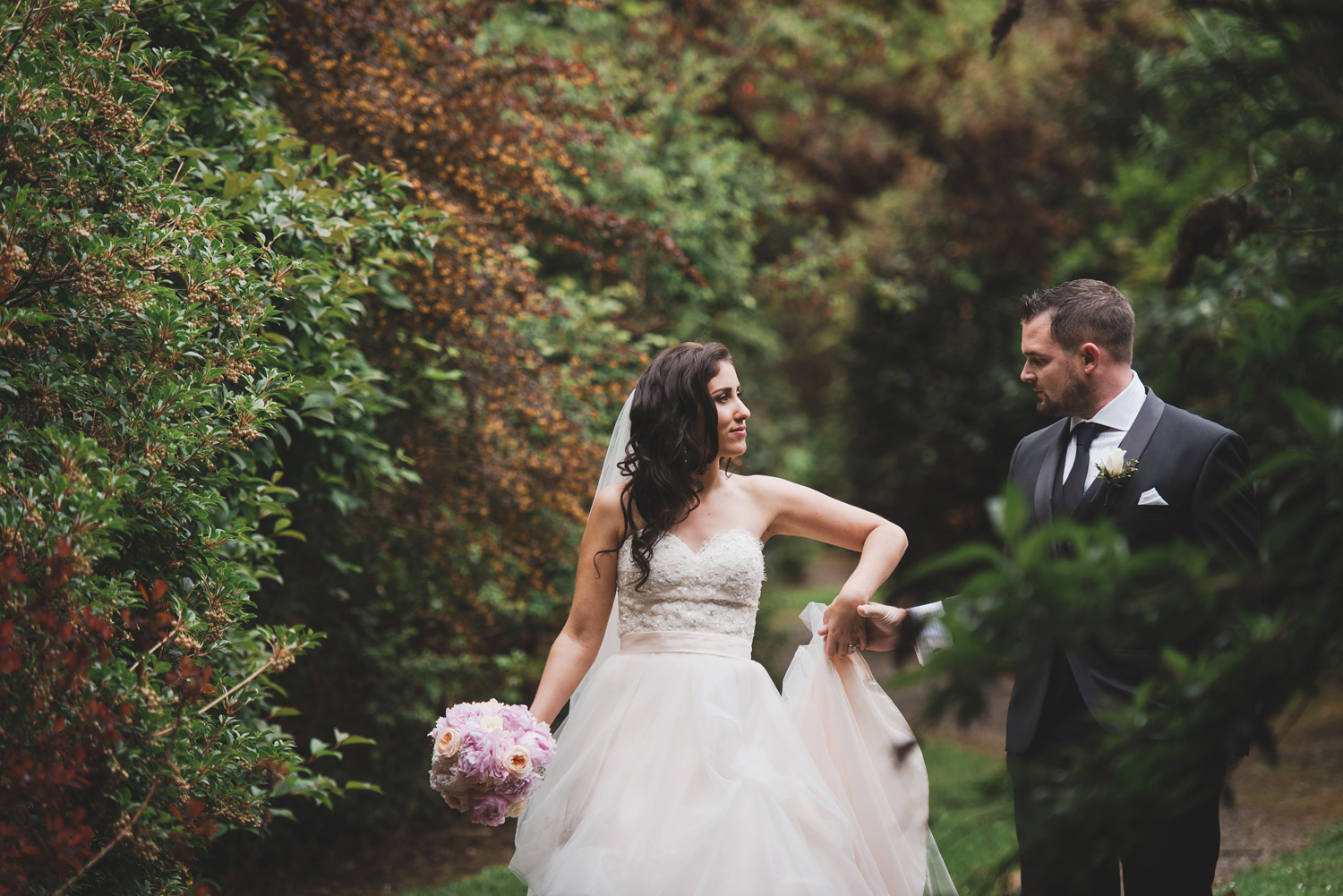 Wedding bride and groom enjoy a quiet walk through Waterford Castle Woods. Wedding Photography Waterford, Ireland.