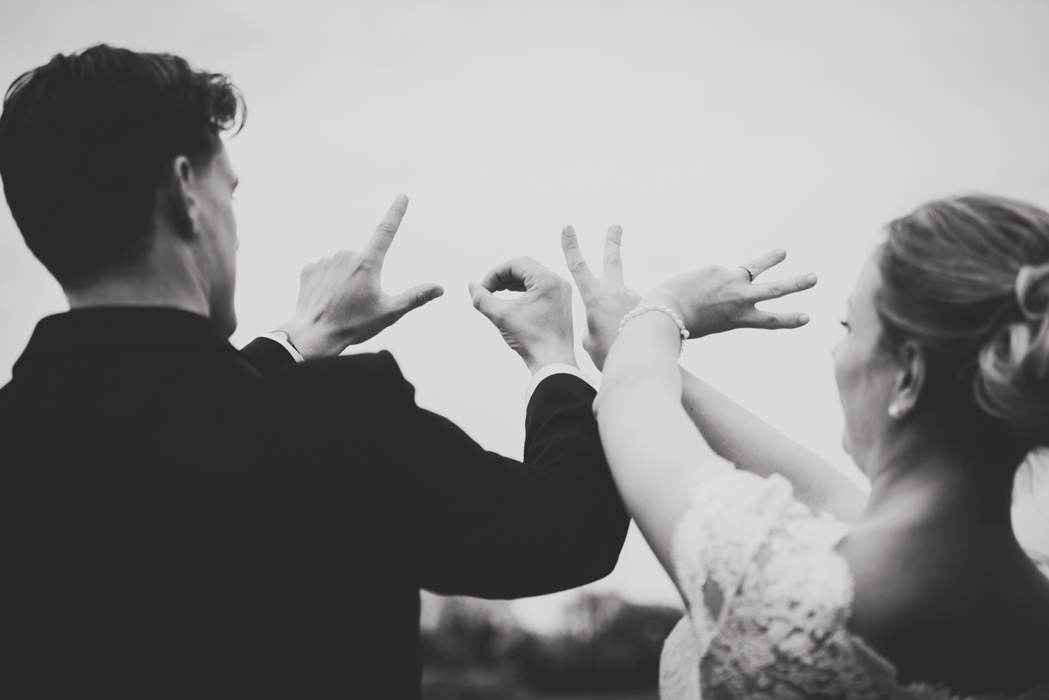 Bride and groom write LOVE in the air with their hands. Roganstown Hotel Wedding. Dublin Ireland wedding photography.
