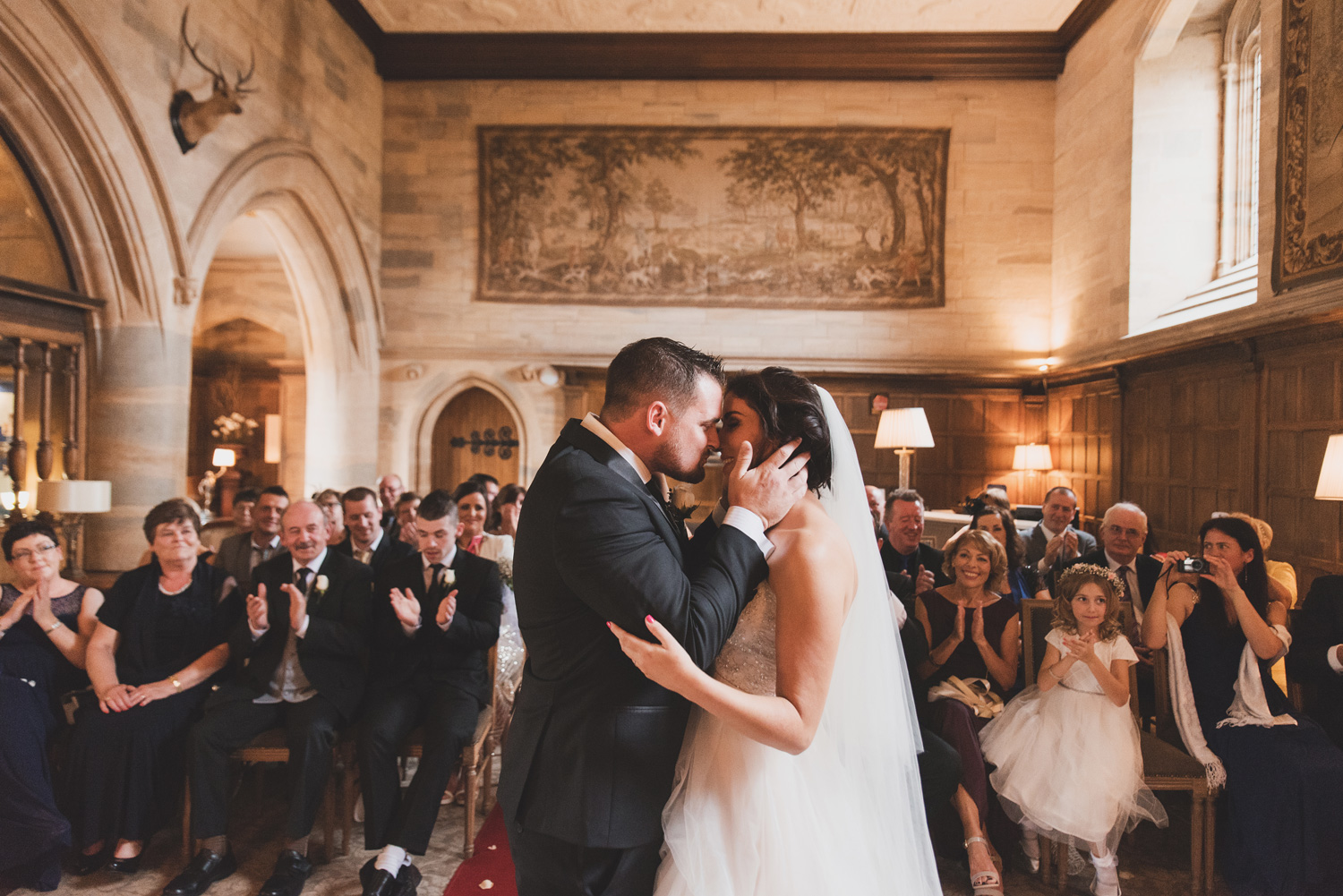Couple kissing during ceremony in Waterford Castle. Wedding photographers Ireland.