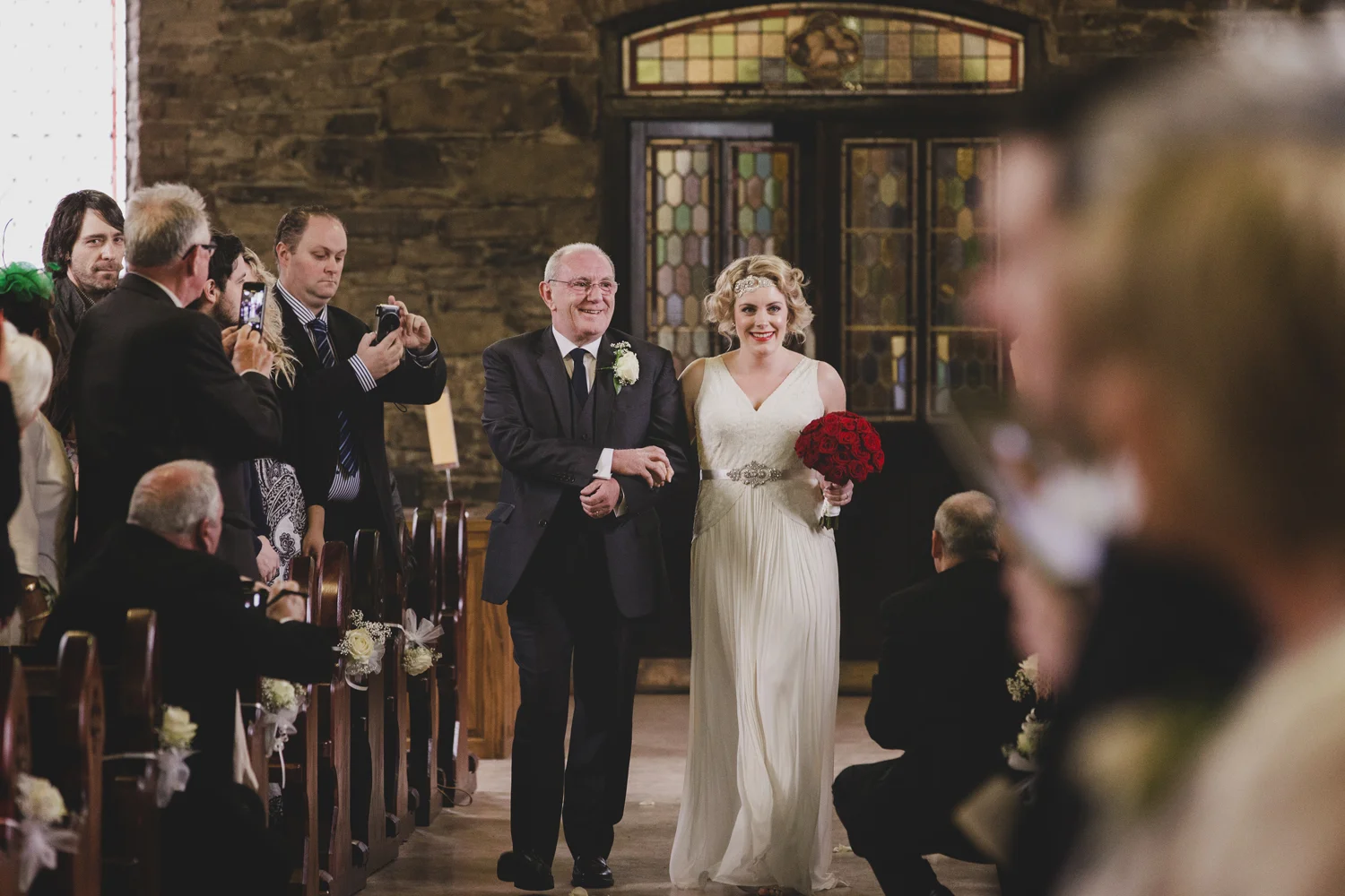 Father walking daughter up aisle in church ceremony. Wedding photography Wicklow.