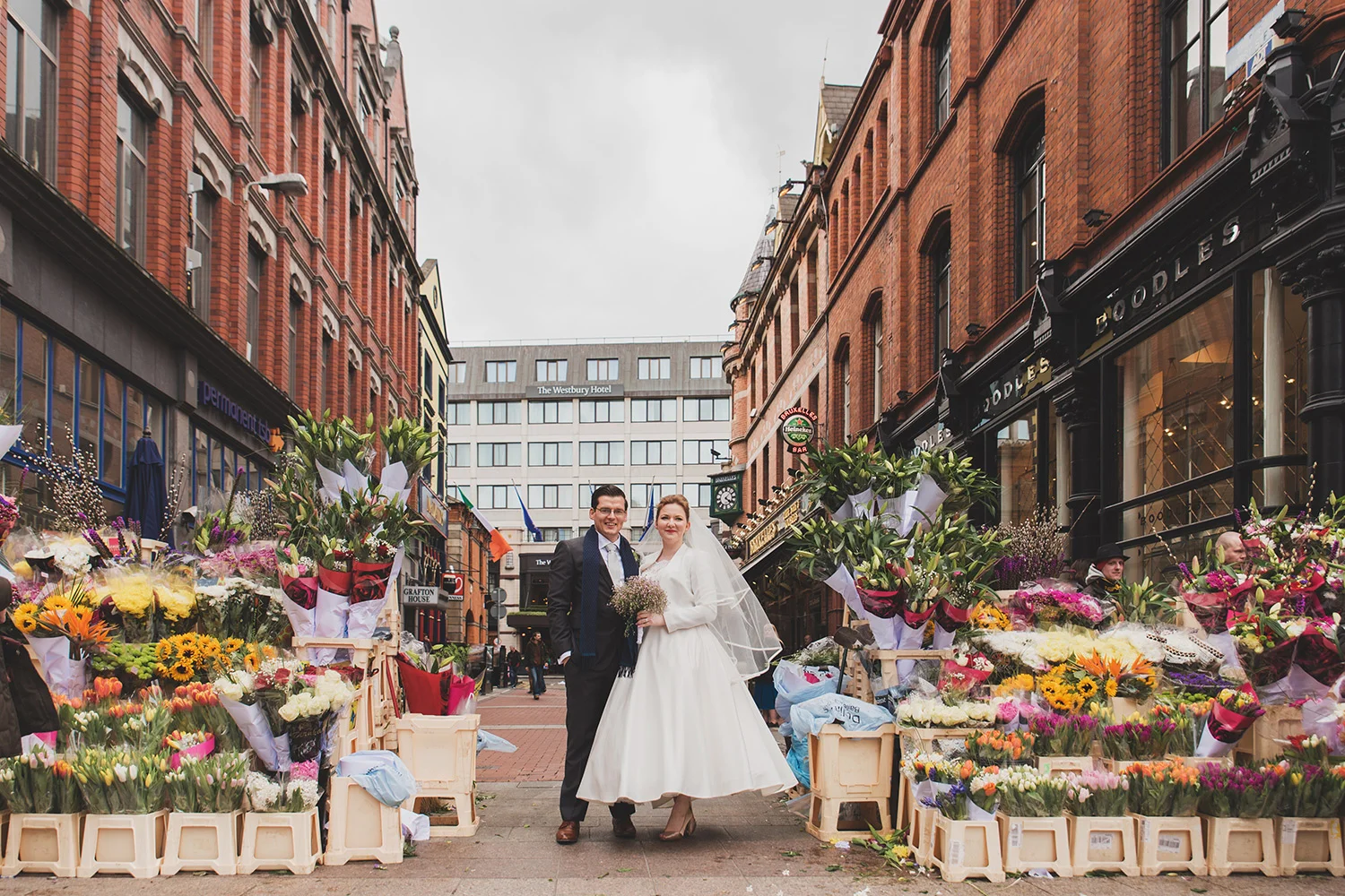Bride and groom at the flower stall on grafton street dublin wedding photographer