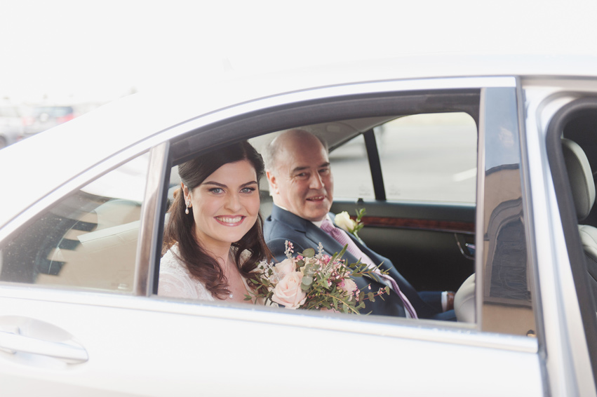 Father of the bride and bride in car on the morning of the wedding