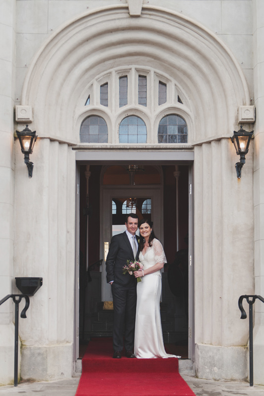 Bride and groom in doorway of bellingham Castle Hotel