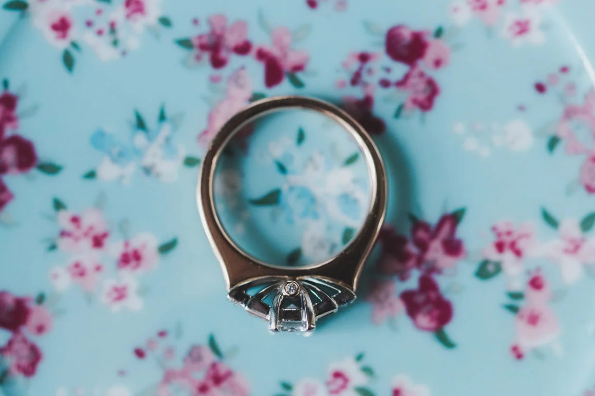 Wedding ring on a blue and pink floral background