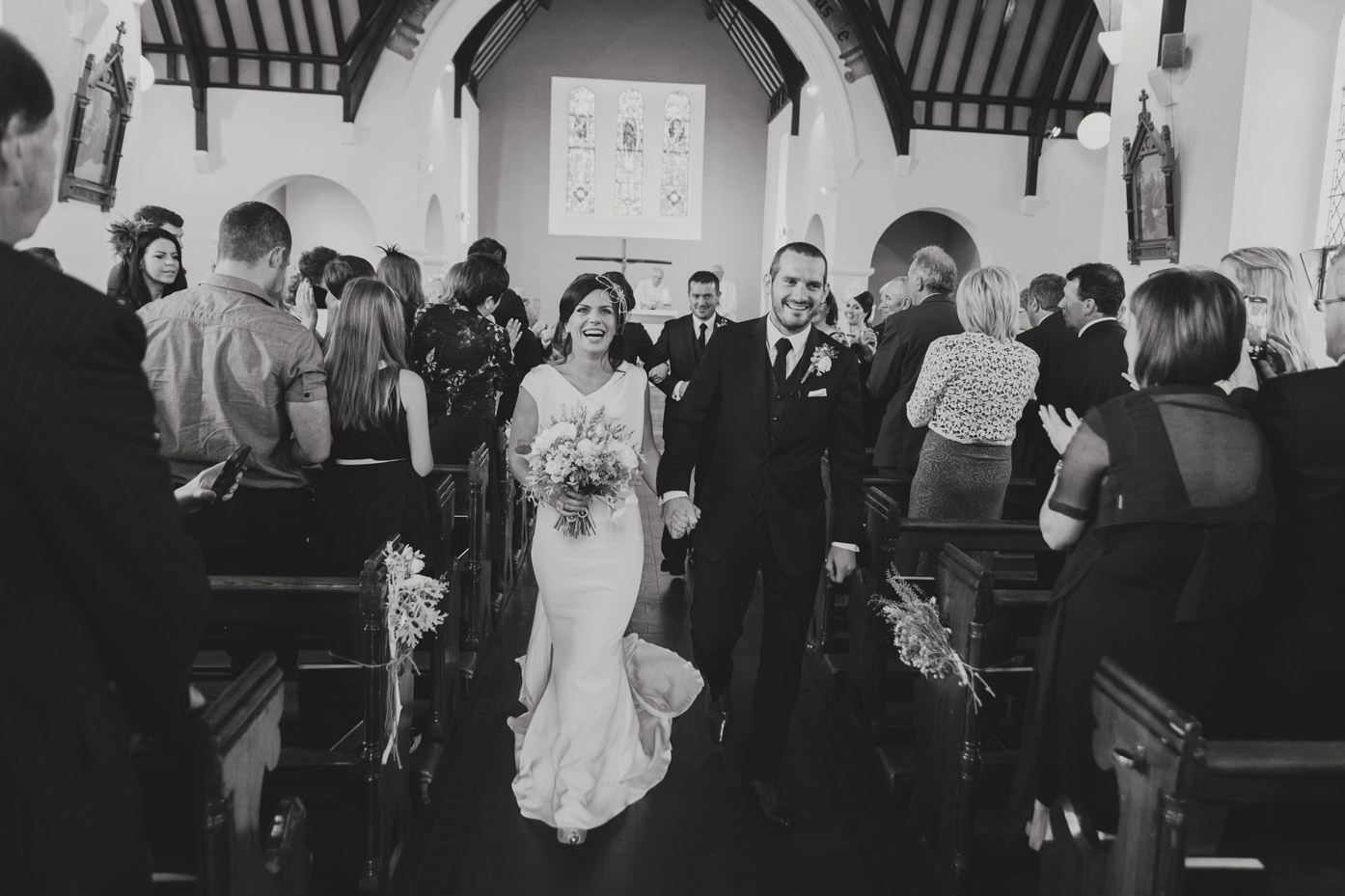 Bride and groom just married leaving church in meath. Ireland. Wedding photographers.