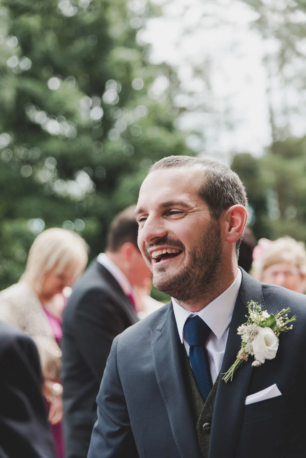 Groom laughing outside church. Wedding photographers meath.