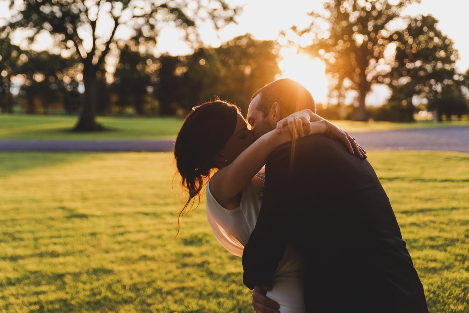 Bride and groom kissing at sunset in Tankardstown House Meath Wedding photographers meath ireland