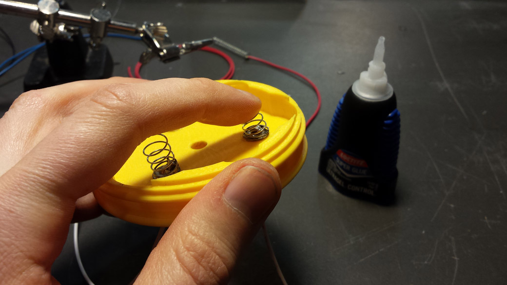 The Positive Terminals are short springs soldered to the washers and super glued into place