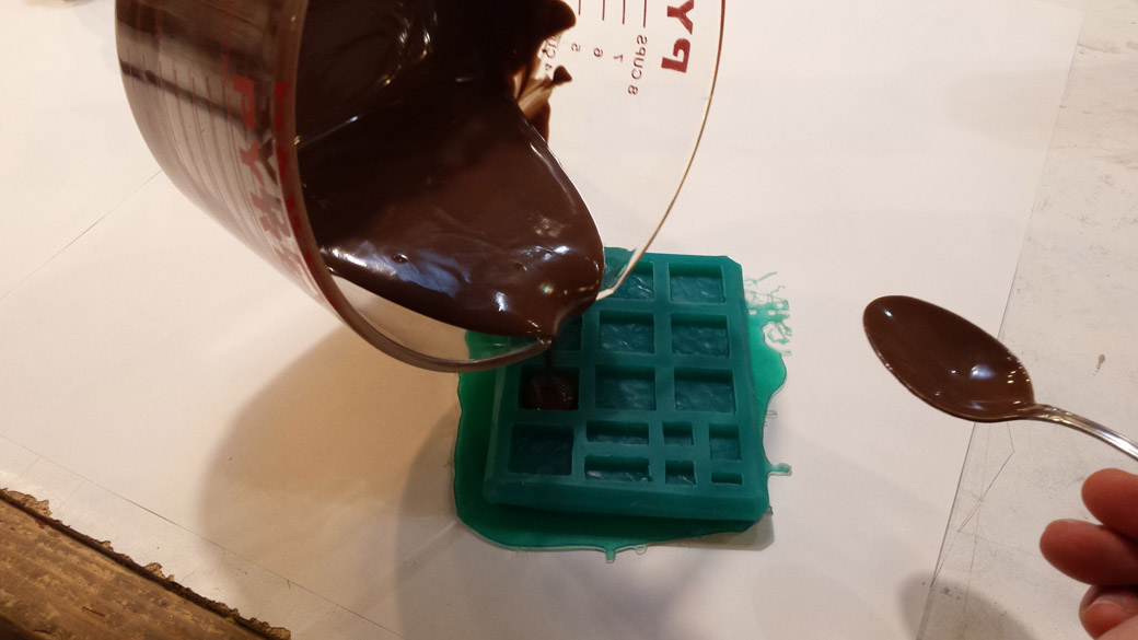 Pouring molten Chocolate into a test mold