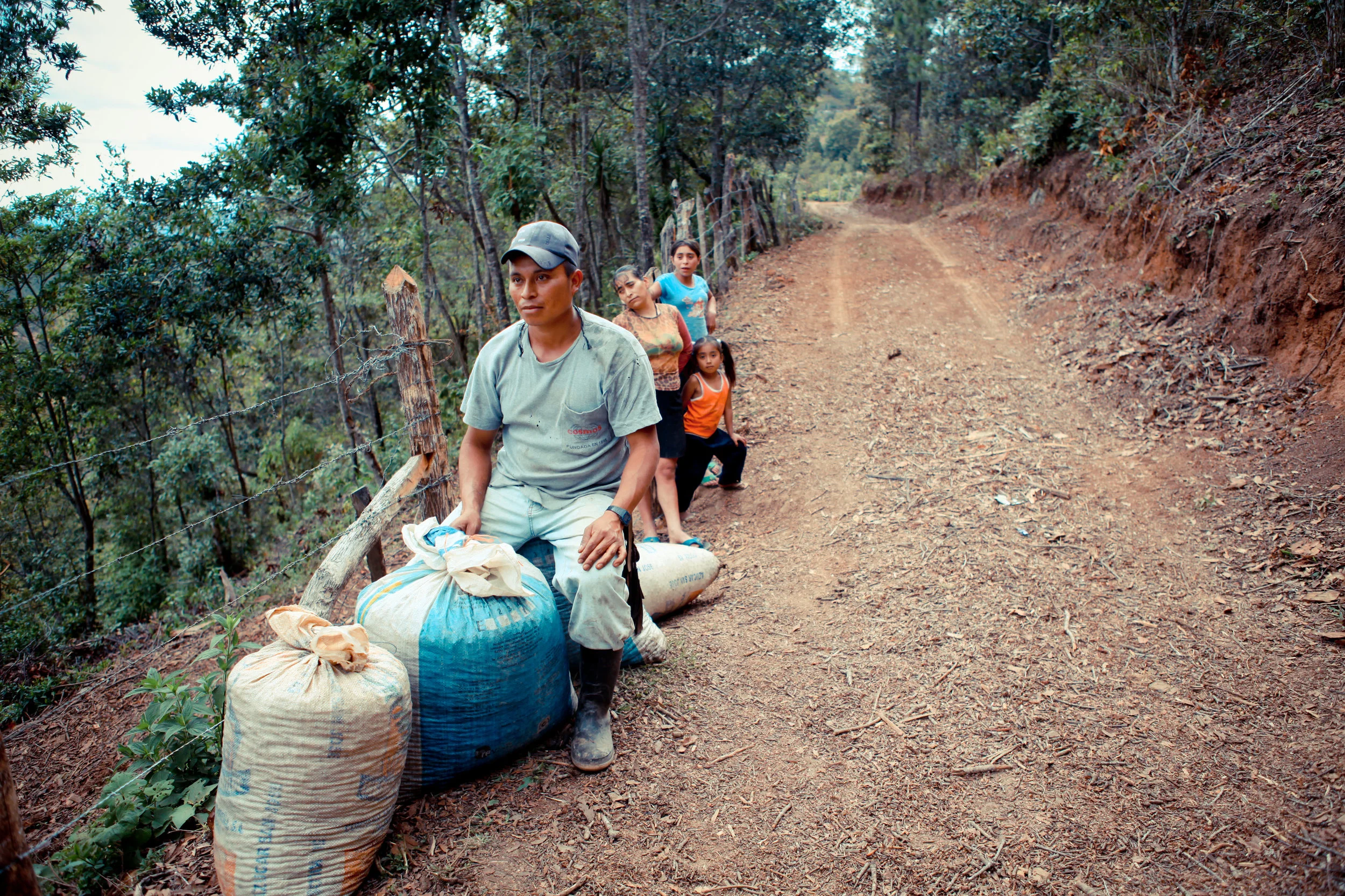 Catracha farmers with part of their yearly harvest. Many farmers in the group are very small producers, like this woman.