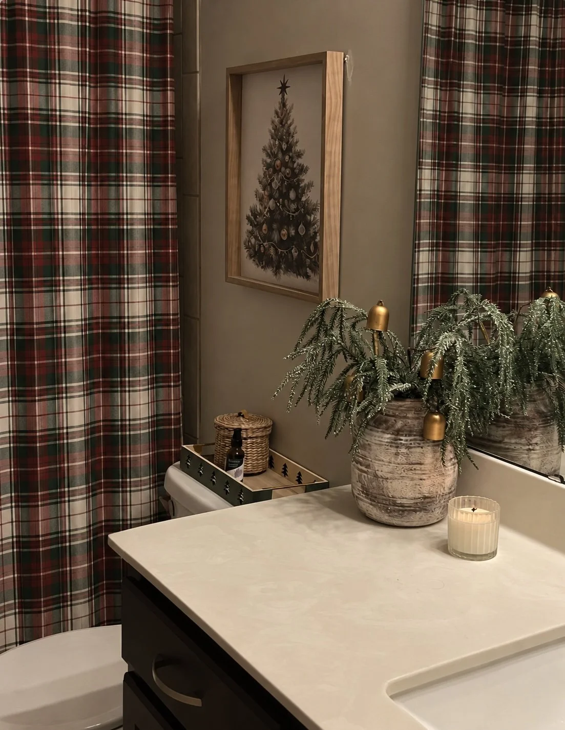 Christmas bathroom with a red, green and cream tartan plaid shower curtain