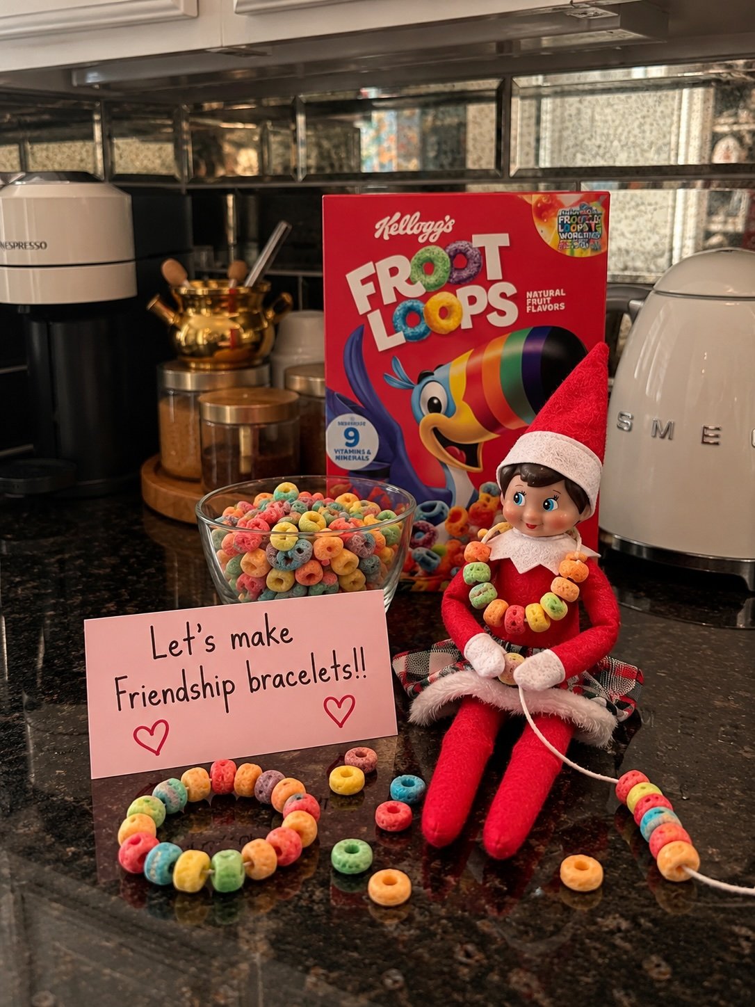 Elf on the Shelf making cereal friendship bracelets on pipe cleaners