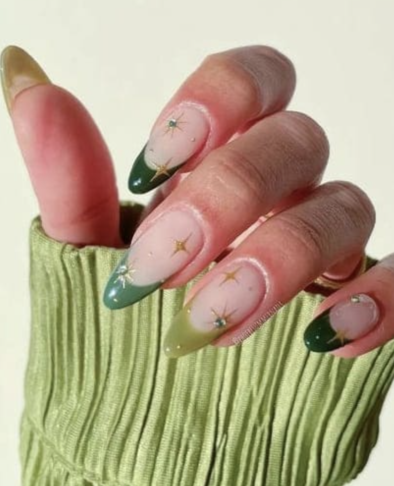 Green French tips with golden starburst accents