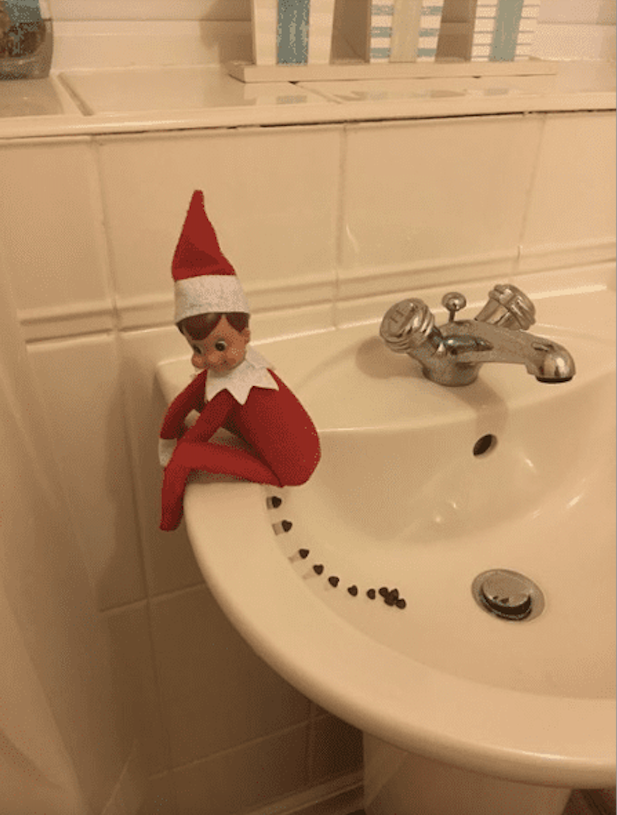 Elf on the Shelf with a trail of chocolate kisses