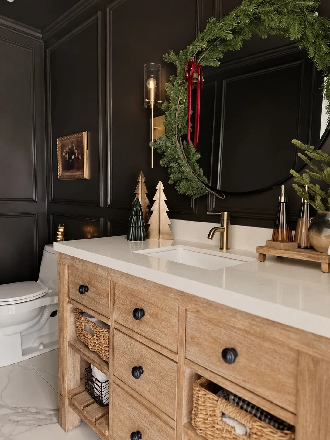 Moody Christmas powder room with black paneled walls