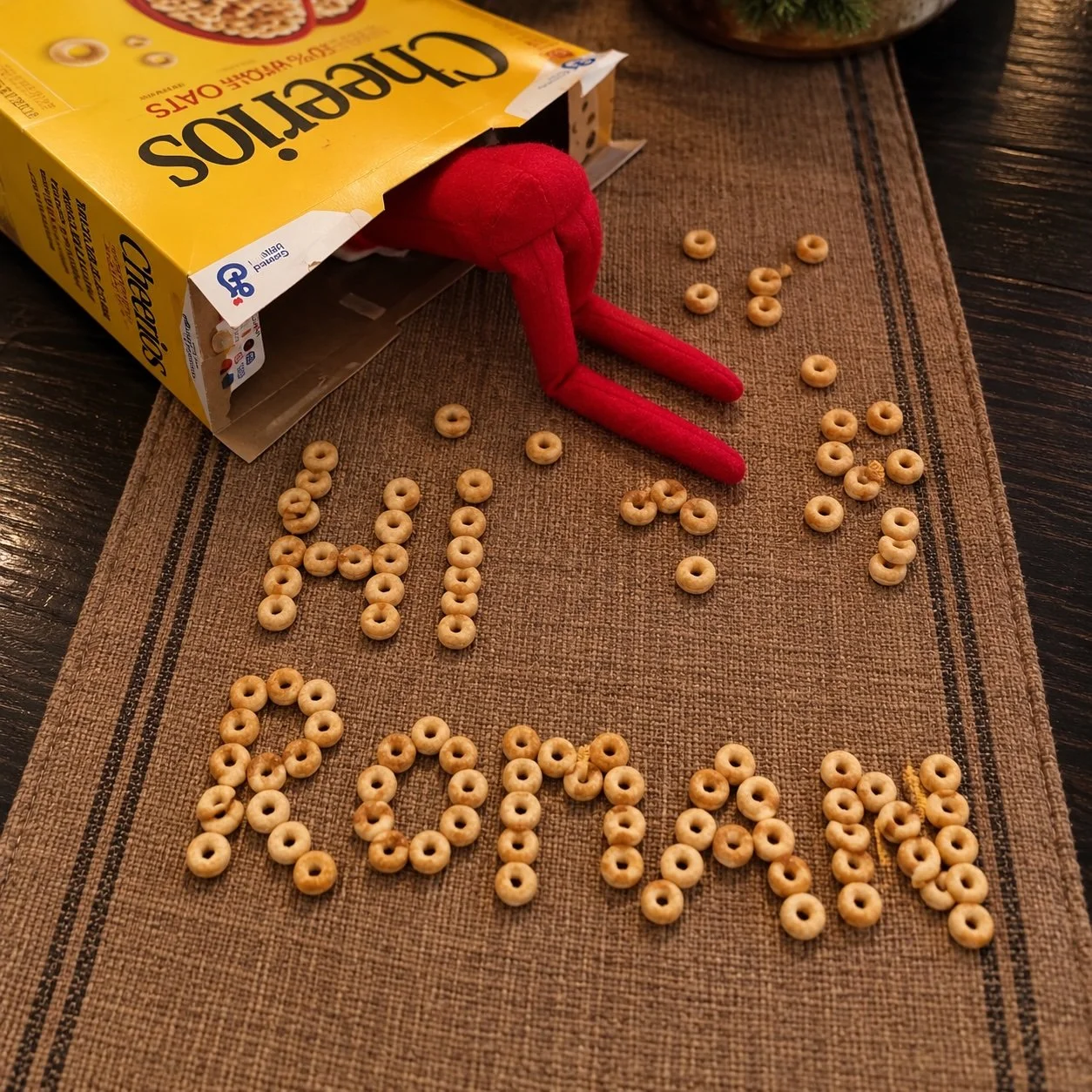 Elf on the Shelf spelling a child's name in Cheerios
