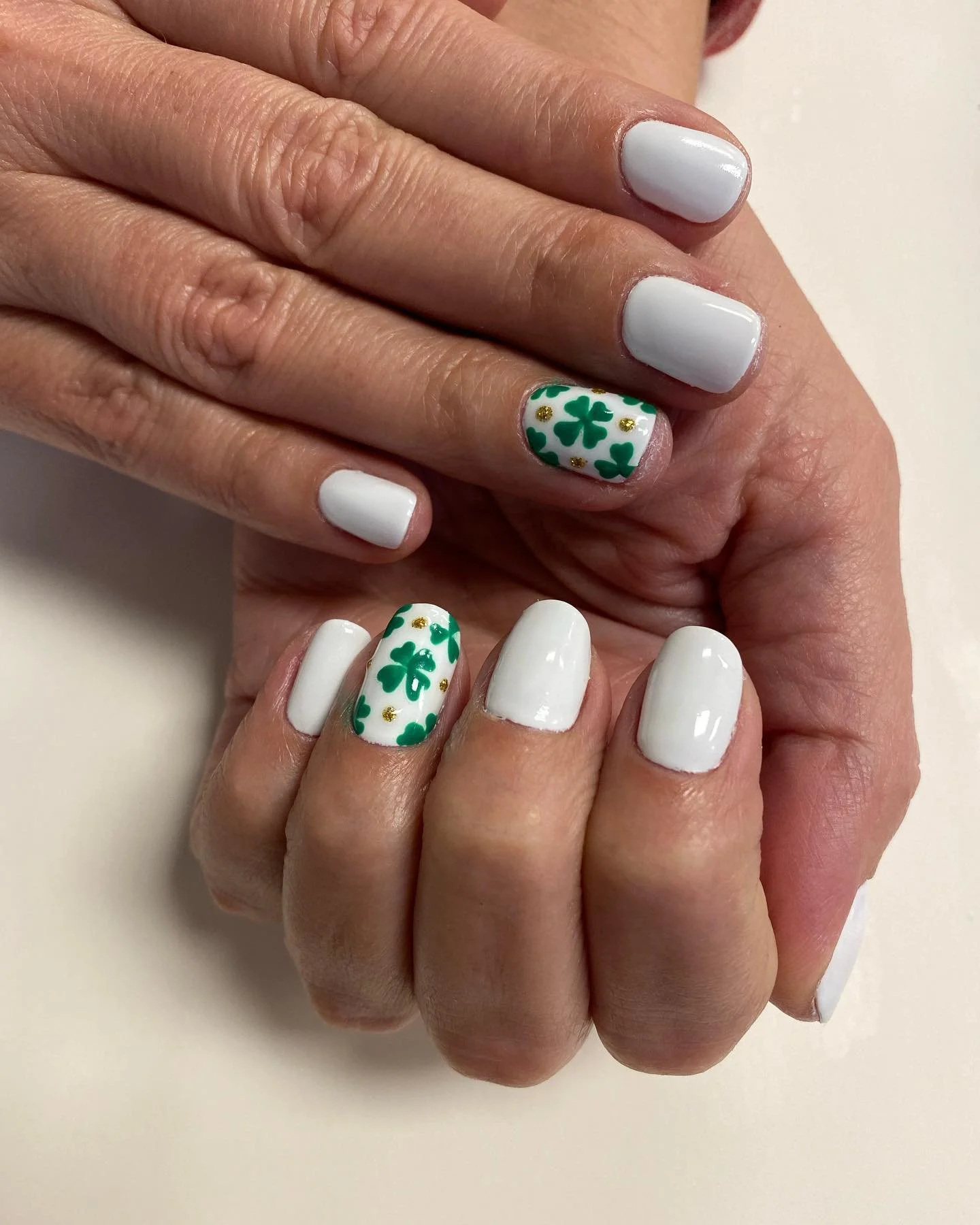 white manicure with shamrocks