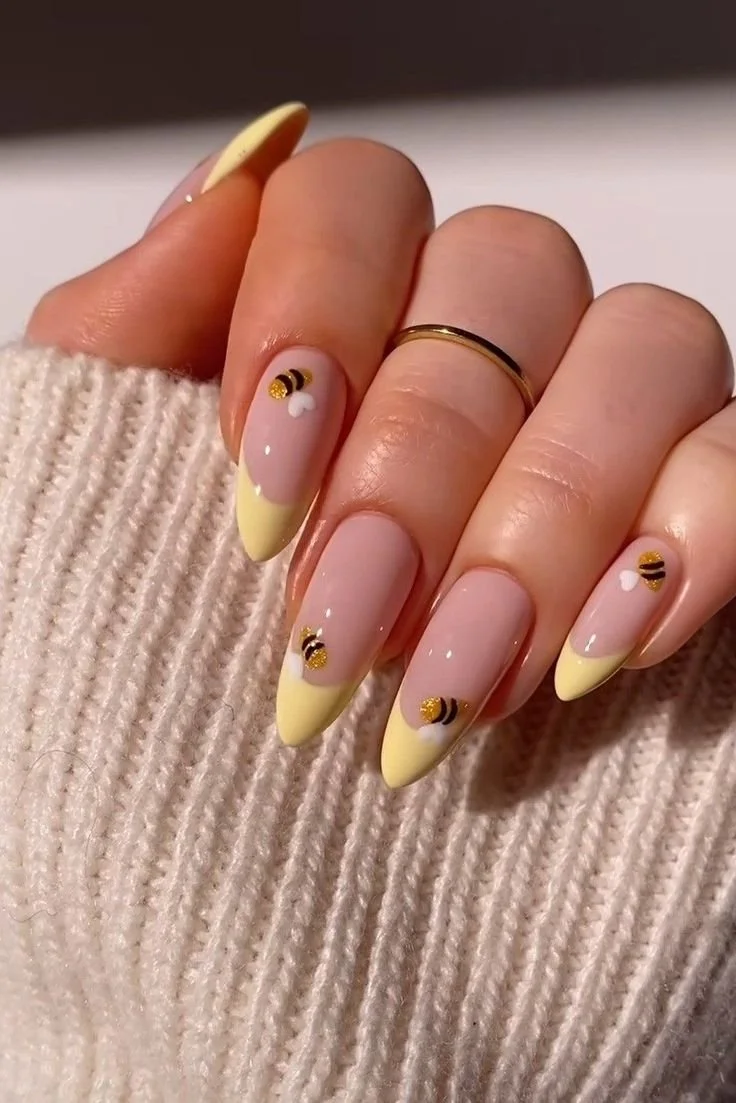 yellow french nails with bumble bees.jpeg