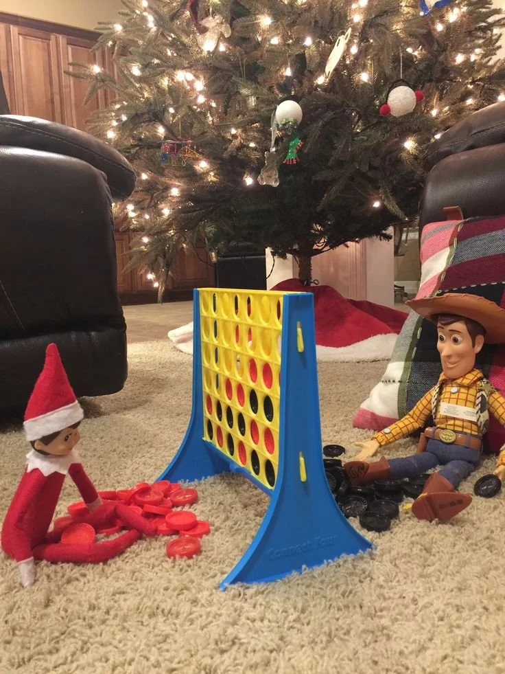 Elf on the Shelf playing Connect 4 with a toy