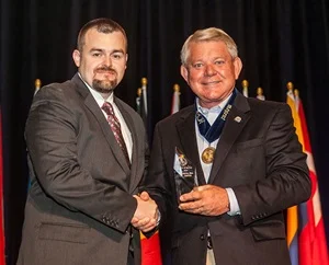 Ryan Hubbs, CFE, accepts the award from ACFE President and CEO Jim Ratley, CFE.