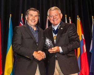 Bill Vasiliou, CFE, accepts the award from ACFE President and CEO Jim Ratley, CFE.