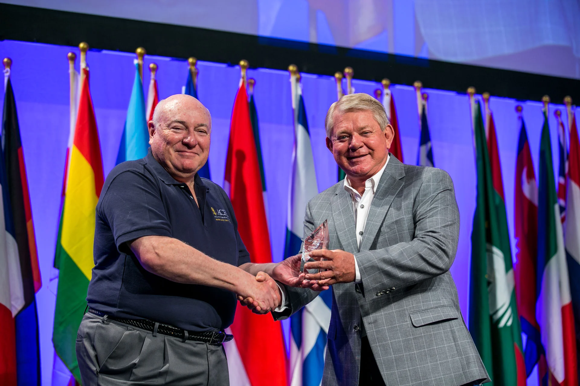 John Grimes (left), president of the Maryland Chapter accepts the Chapter of the Year award from Jim Ratley, president and CEO of the ACFE.