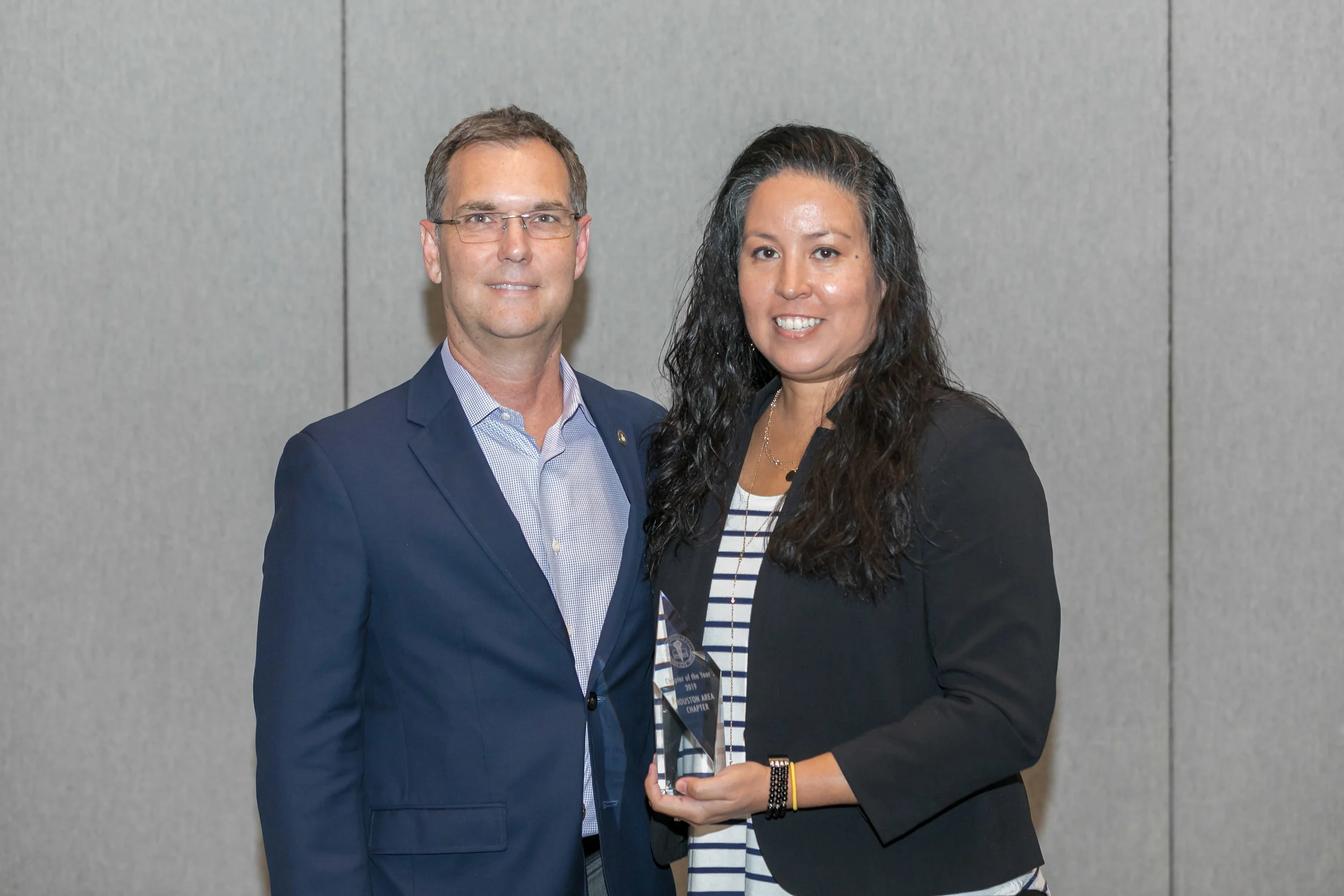 ACFE President Bruce Dorris presenting the Chapter of the Year Award to Houston Area Chapter President Chrysti Ziegler.