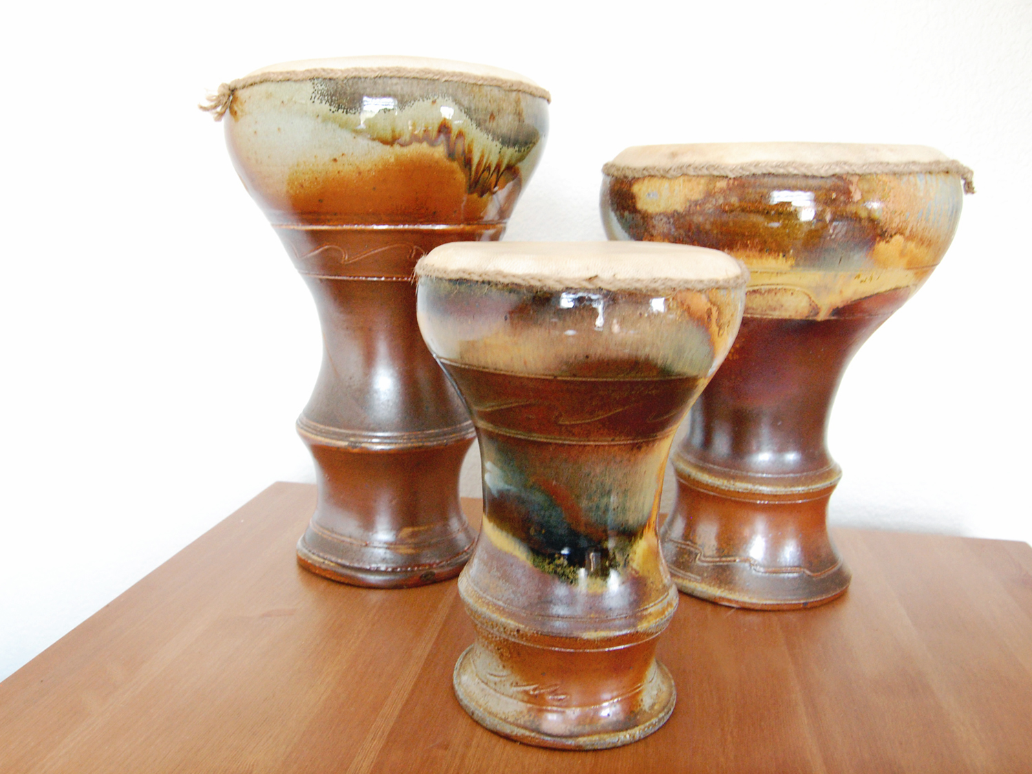 3 finished doumbeks together. I love how they look wood fired!