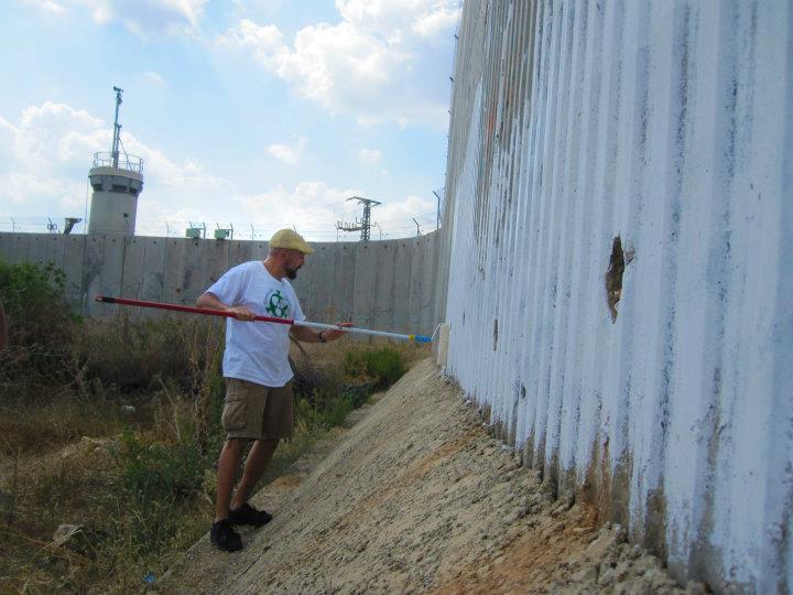 Laying out a Peace mural on the security wall in Qalqilya, Palestine