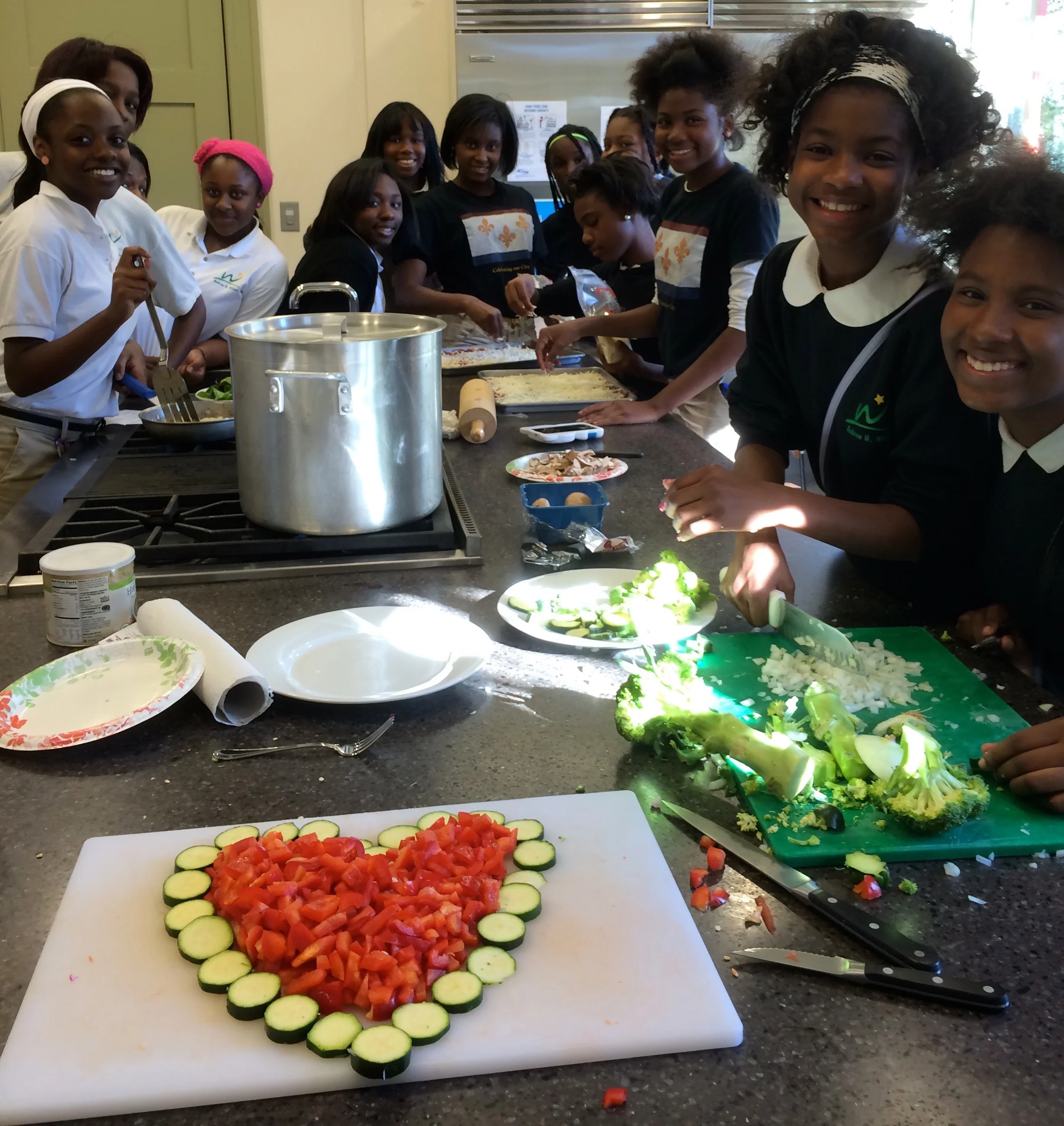 Andrew H. Wilson Charter School students at the Rosa F. Keller Community center prepare an afternoon snack using vegetables from the school garden.