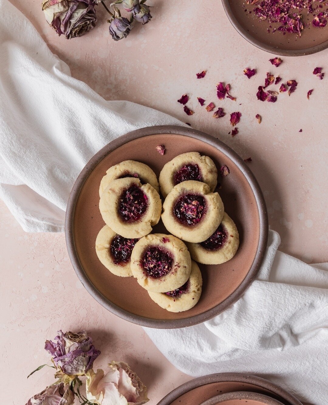 Tart cherry jam with just a hint of rose centered around the balanced, nutty aroma of the most tender, chewy vanilla cookies. No, this is not a description of the newest Bath &amp; Bodyworks lotion! Cherry Rose Thumbprint cookies are on the blog &mda