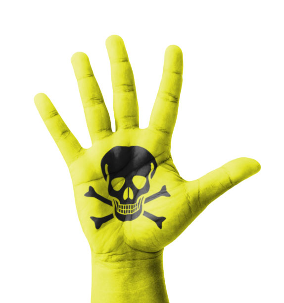 Image of poison skull and crossbones on yellow hand for blog post about how not to poison yourself recycling precious metals. Credit: iJacky/iStock.
