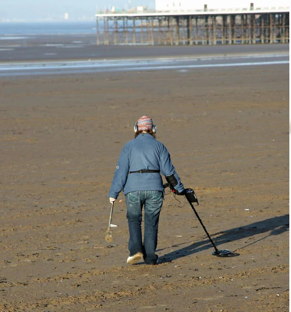 Now that the summer crowds are gone, it's the perfect time to search for precious metals on the empty beaches with a metal detector. Credit: TACrafts/iStock