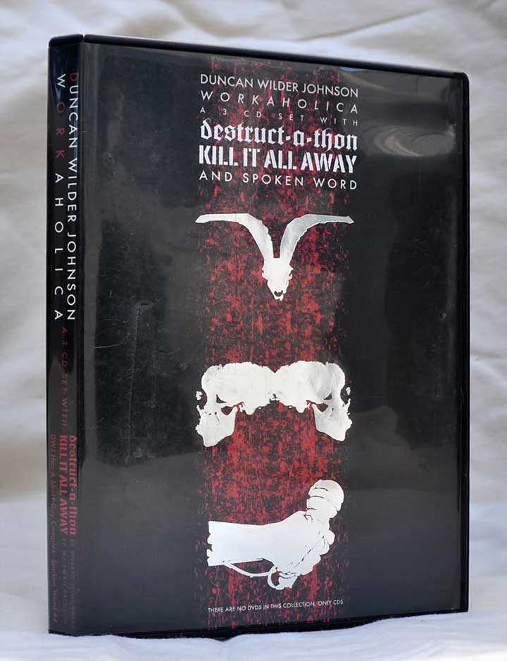 Workaholica 3 CD Box Set (Front), Illustration and Design by Duncan, Destruct-a-thon Pigmy Goat Skull by Ed Bredenberg, Microphone Hand by Joe Alterio