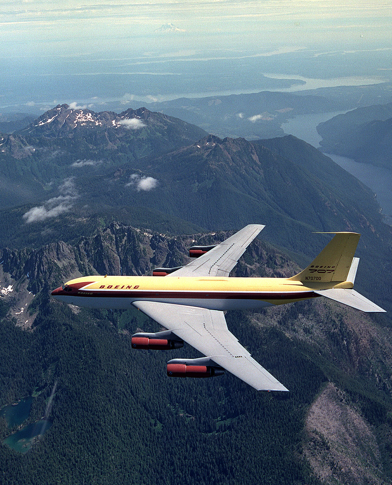 The Dash 80 flies over the Olympic Penninsula on its way to the Smithsonian in 2003 (Joe Parke)