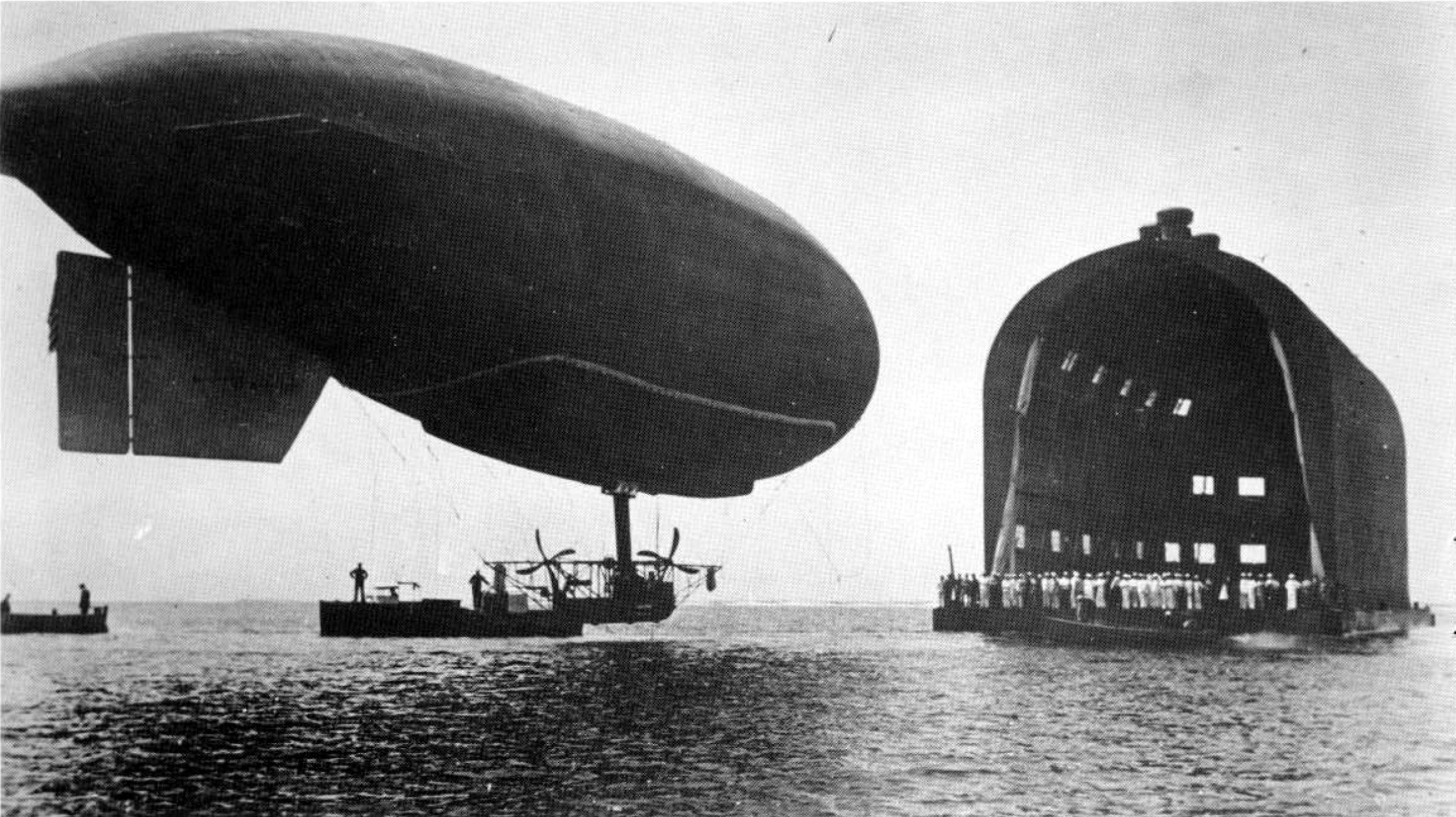  The DN-1 dirigible being guided to its floating hangar in Pensacola, Florida.&nbsp; 