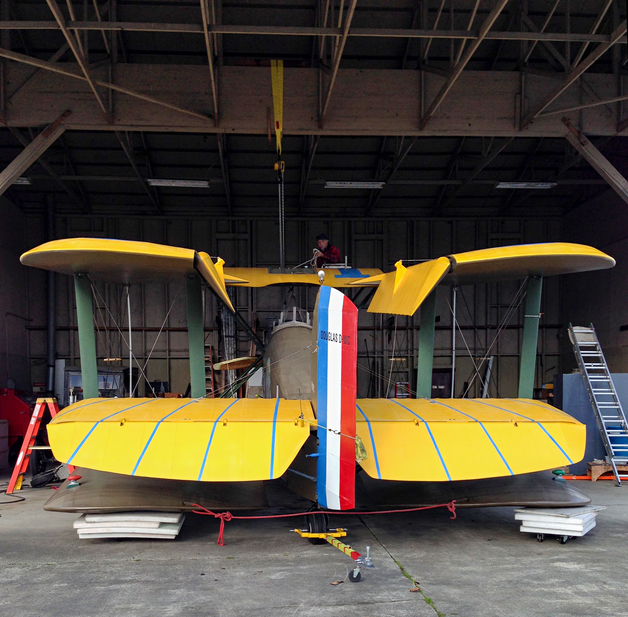 Bob on top of Cruiser, getting rigging prepared for lift. Note the hoist goes through the top wing tank.