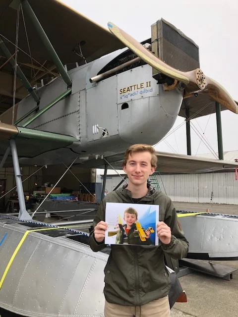 A number of years ago Ryan Zulauf, former Renton Airport Manager, and his son Cole built a model of a World Cruiser. Cole recently stopped by the hangar to visit with us and share this great photo of he and the model they built.