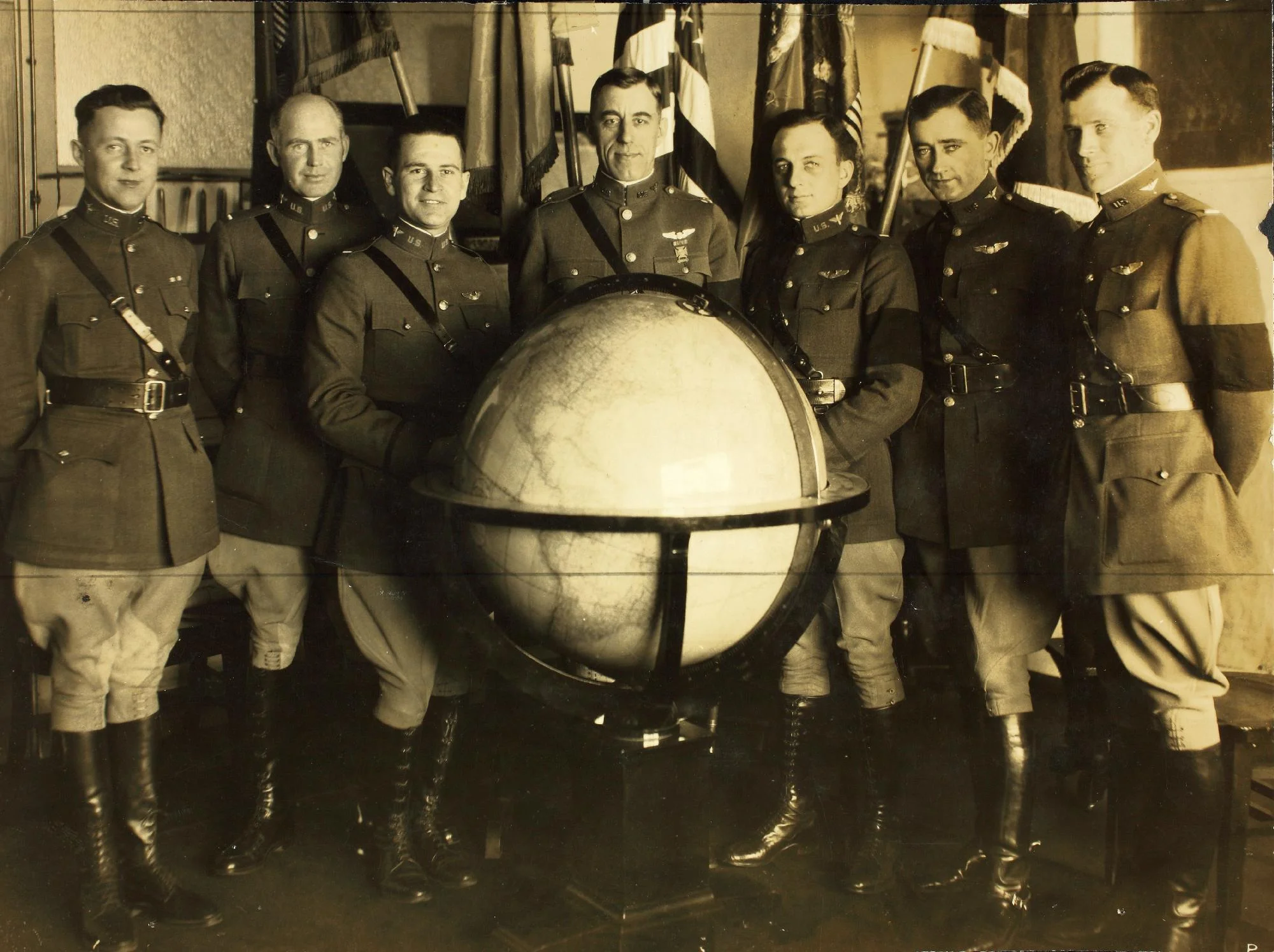 The World Flight Crews (Left to Right): Lt. Jack Harding, Lt. Erik Nelson, Lt. Leigh Wade, Maj. Frederick Martin,Lt. Lowell Smith, First Lt. Leslie Arnold and Lt. Le Clair Smith. They are wearing black arm bands in honor of former U.S. president Woodrow Wilson, who had recently passed away.